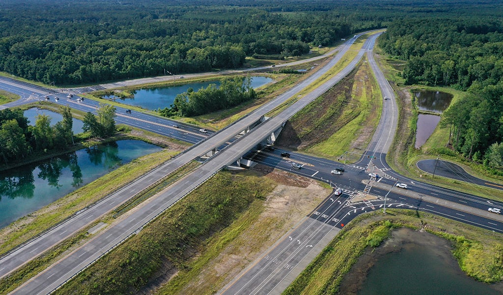 an aerial view of a highway interchange near water