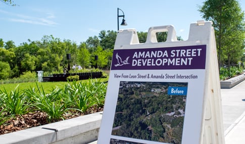 A sign displays information about the Amanda Street Development