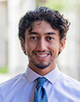 Adrian Santiago smiling wearing a tie