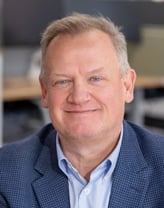 Andy Gillespie smiling while looking at the camera.