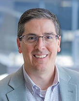 Chris Fronheiser smiling at the camera.