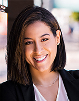 Day Perez leaning against a window smiling.