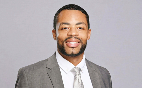 Jarrell Smith wears a gray suit and tie