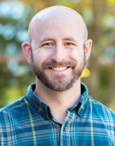 Jeff Bachiochi smiling in a blue plaid shirt.