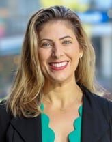 Julieanne Herskowitz smiling in a colored shirt and dark blazer.