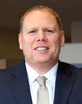 Ryan McAlister smiling in an office.