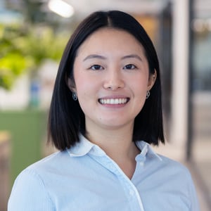 Rica Ueda smiling in a white blouse.
