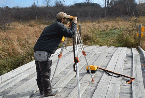 A surveyor works in the field.