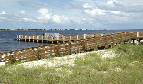 A boardwalk climbs over the sand dunes at Gulf Islands National Seashore.