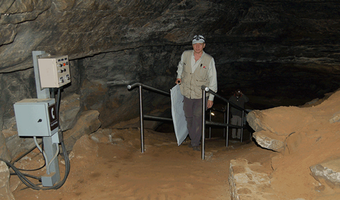 A man walks up a trail inside Mammoth Caves