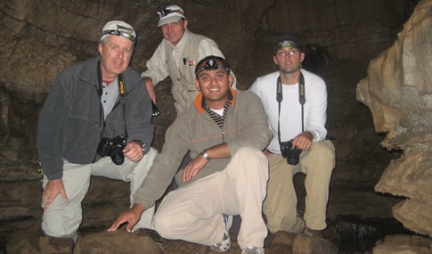 Four men pose inside Mammoth Caves.