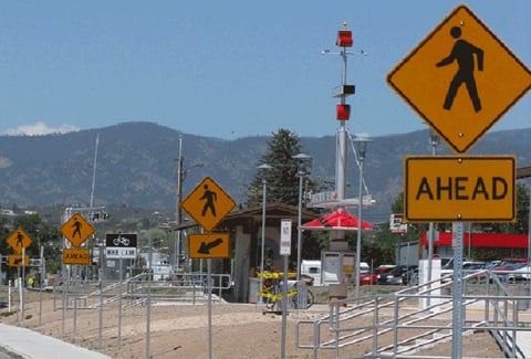 Road signs show pedestrians where it is safe to cross the street.