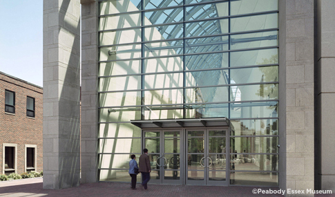 Glass-enclosed arched entrance to Peabody Essex Museum. 