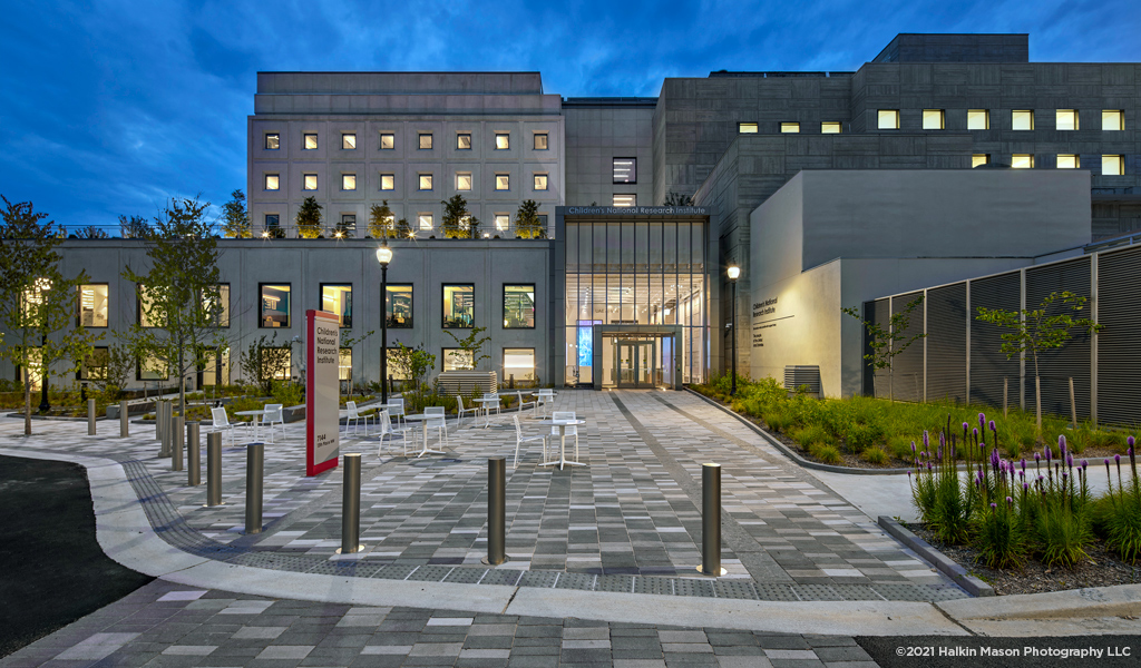 A view of the front entry of Children’s National Research Institute at dusk. 