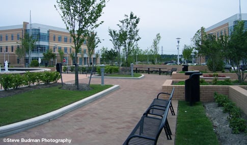 Paved outdoor seating area with benches on the Princess Anne Health Campus in Virginia Beach, VA.