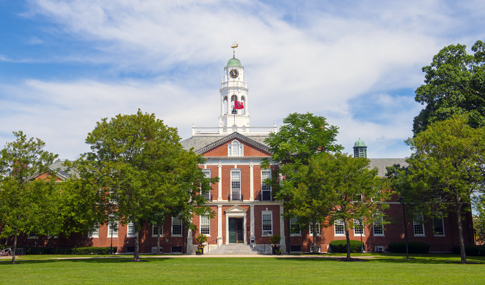Exterior of large, historic brick building on the Phillips Exeter Academy campus.
