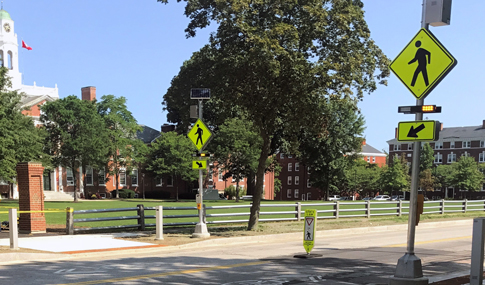 Crosswalk on college campus with newly installed pedestrian safety features. 