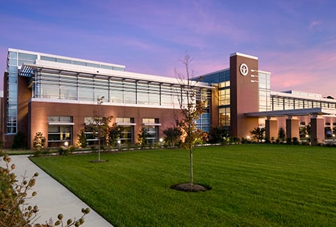 Twilight view of main entrance to LifeNet Health headquarters building.