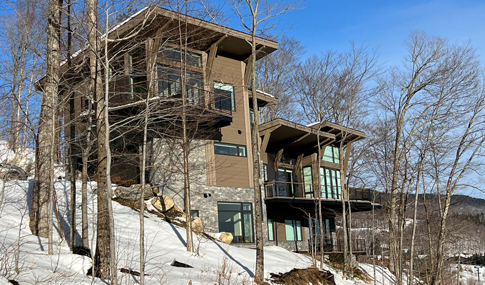 View of Switchback Terrace Drive and new homes set on a mountain in winter.