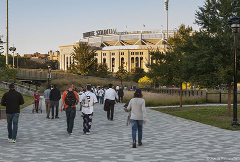 Pedestrians walk toward Yankee Stadium in New York.