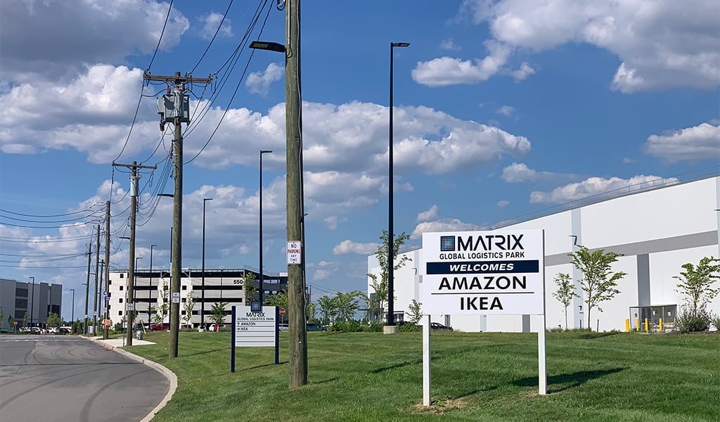 A sign welcomes Amazon and Ikea to the industrial park.
