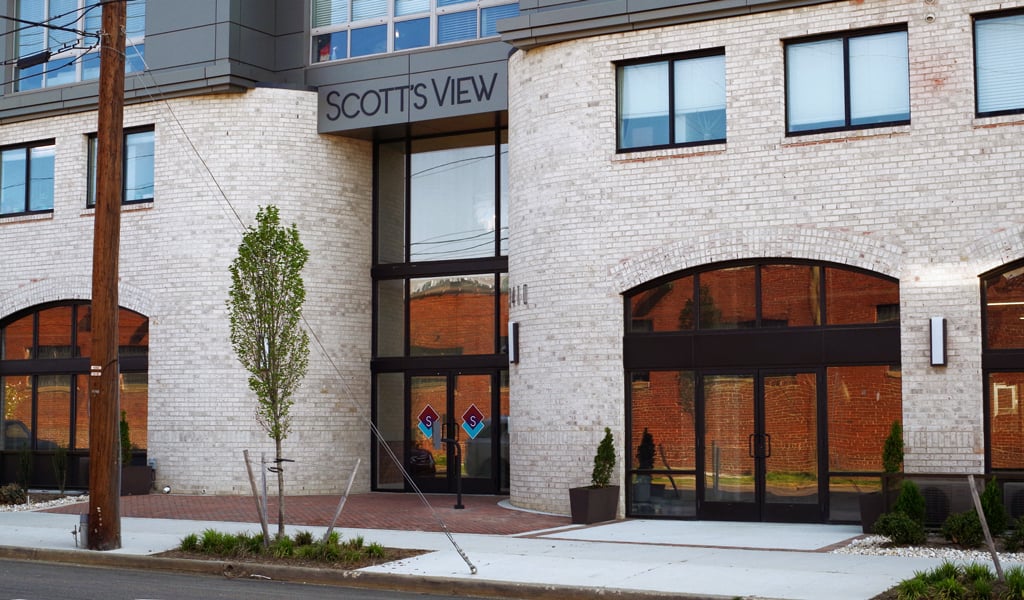 Front entrance to Scott’s View Apartments that includes new trees and plantings along the urban streetscape. 