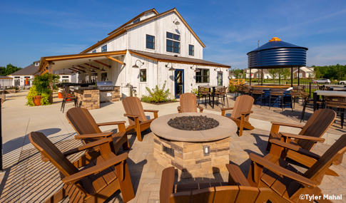 A common gathering space that includes a fire pit and outdoor seating.