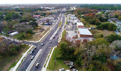 Aerial view of cars driving on Bay Street in Savannah beside a tree-lined median