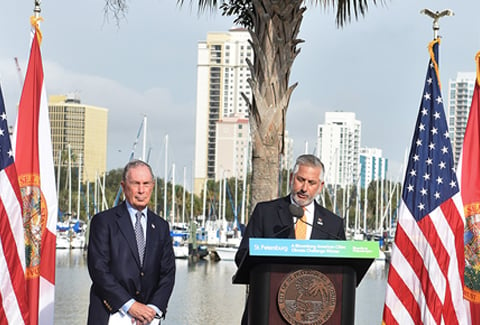 St. Petersburg Mayor Rick Kriseman accepts the American Cities Climate Challenge award from Michael Bloomberg at Albert Whitted Park in January 2019.