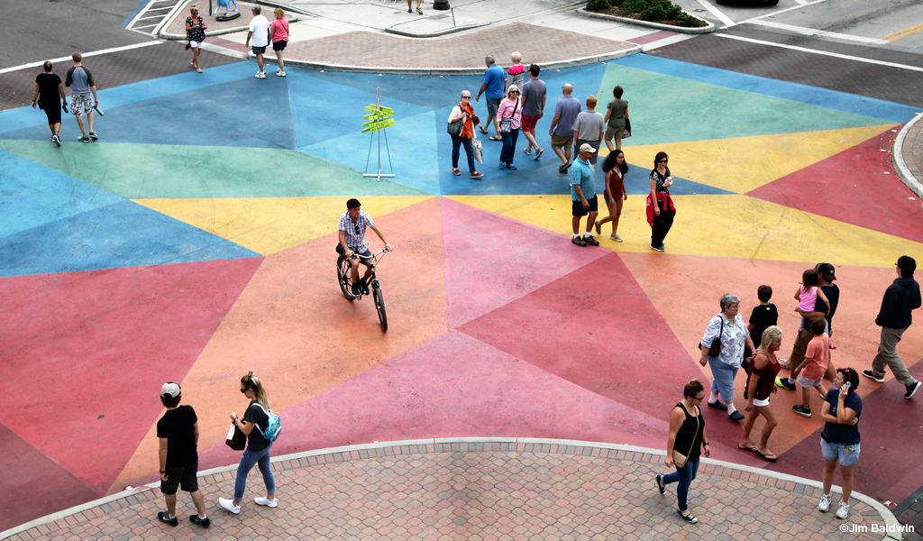 People cross an artistically painted intersection in St. Petersburg.