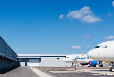 Two Allegiant airplanes sit parked outside the maintenance facility at St. Petersburg-Clearwater International Airport.