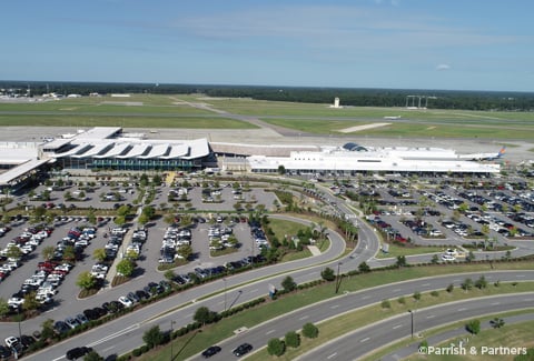 Drone photo of Myrtle Beach Airport terminal, runway, roadways, and parking areas.