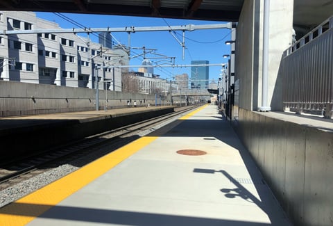 New rail platform with city view in background at Ruggles Station in Boston, Massachusetts.