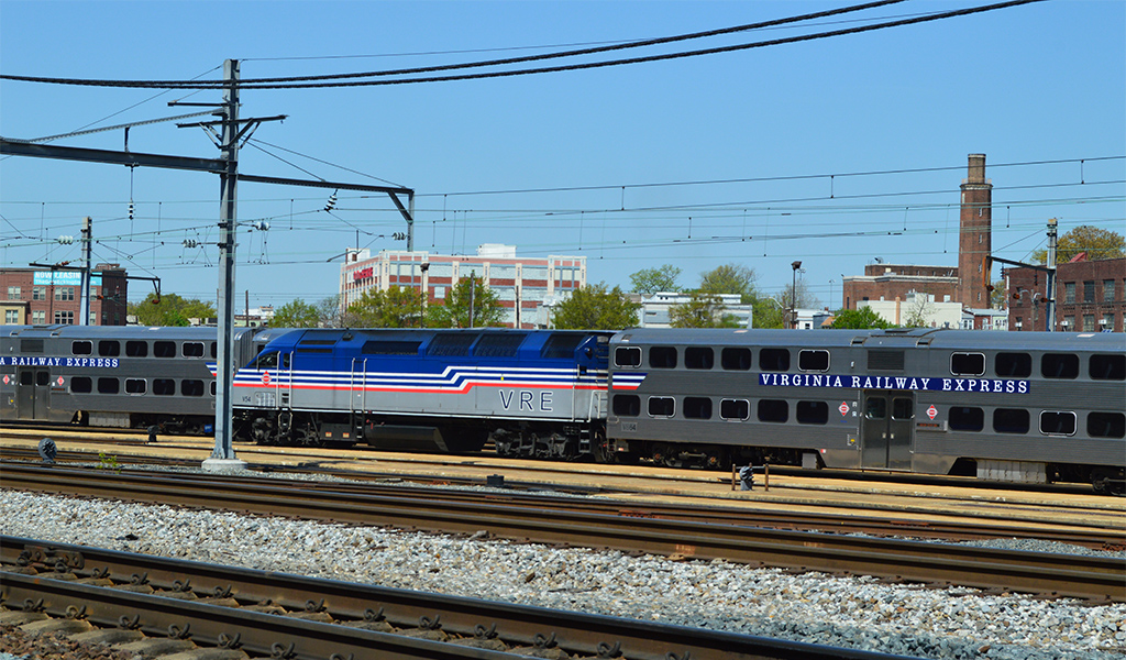 VRE engine and passenger car stationed in railyard