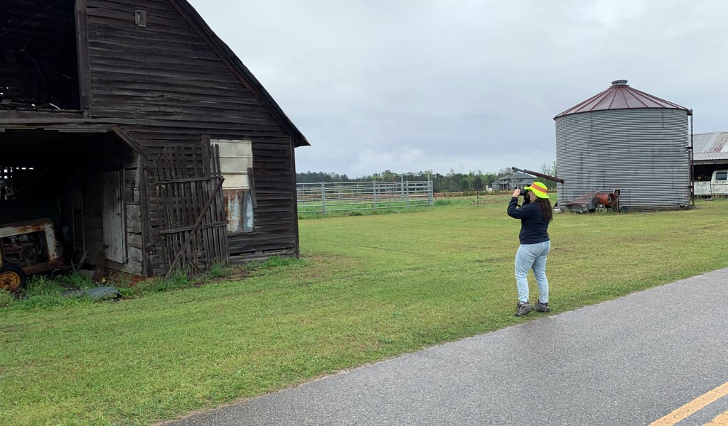 VHB surveyor photographing barn. 