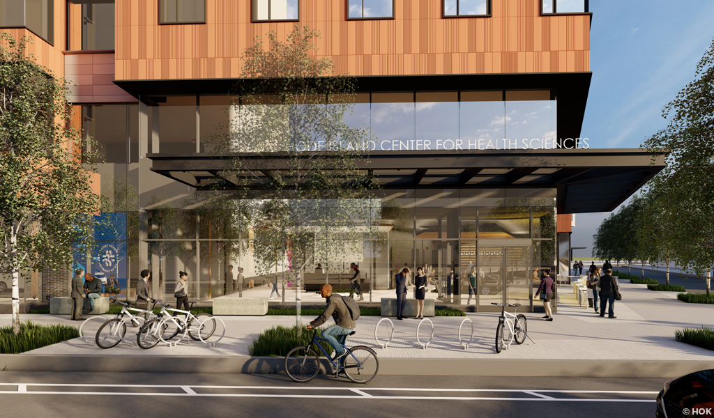 A multi-story building with glass street level and terracotta siding on the upper levels.