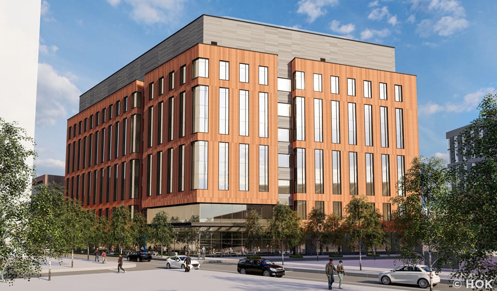 A rendering of a four-story terracotta-clad building with large windows.