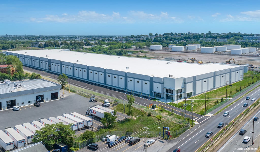 Oblique aerial of a large warehouse on a sunny day with blue skies.