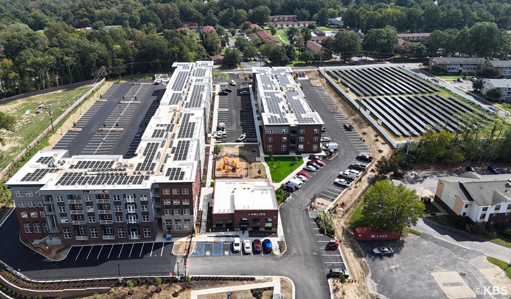 Aerial of Helios, an affordable housing community showing adjacent parcel with solar panels. 