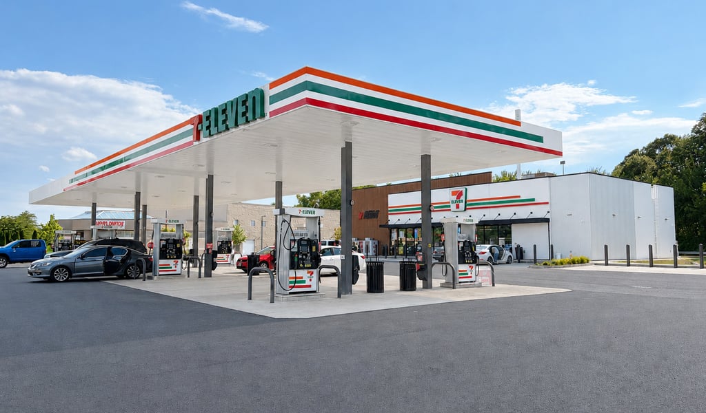 7-Eleven gas station and convenience store on a partially cloudy day with blue sky. 