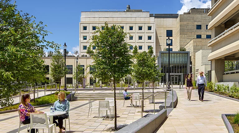Employees and visitors socializing in front of the Children’s National Research & Innovation Campus front entry.
