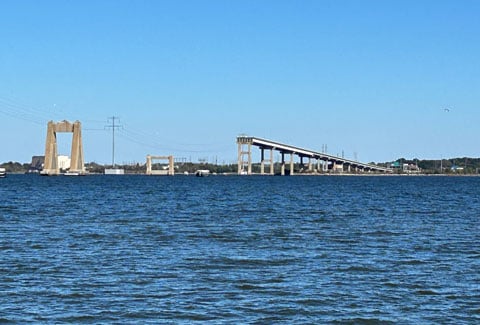 Aeriel view of the Patapsco River with industrial buildings lining the waterfront. 