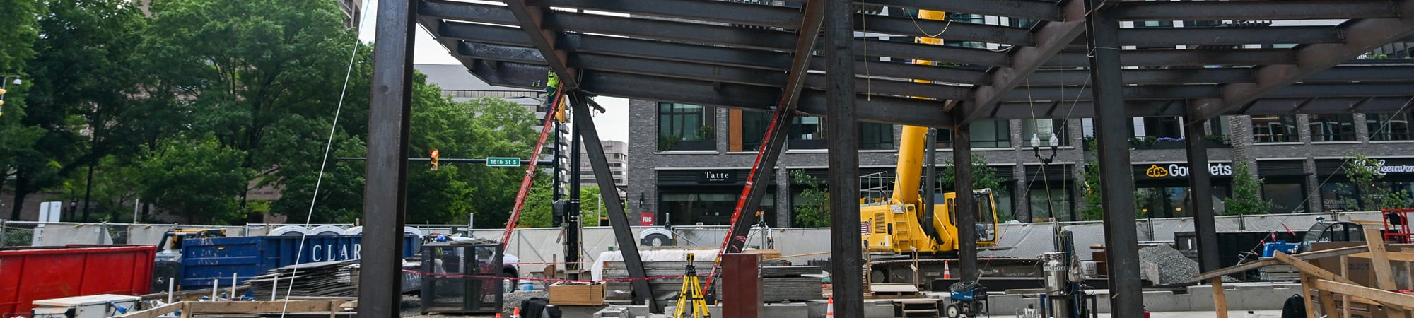 Steel framing under construction at an urban building site.