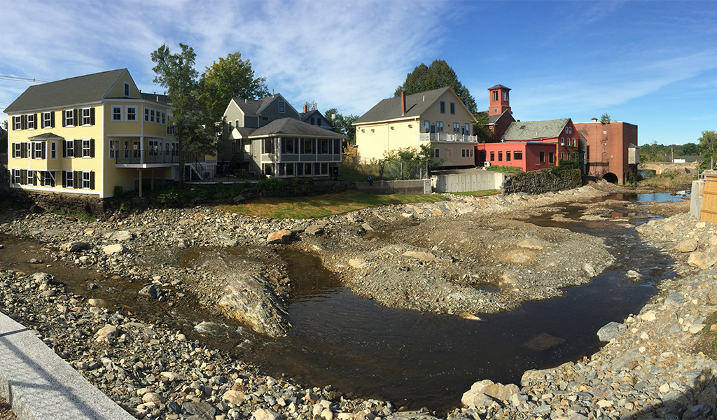 Houses line the bank of the Exeter River after the Great Dam has been removed.