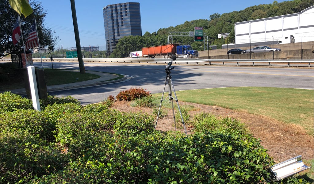 Noise assessment microphone stationed next to I-285 picking up the sounds of passing traffic.
