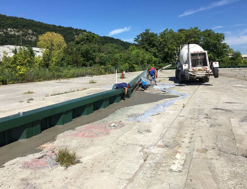 Workers installing sheet pile wall.