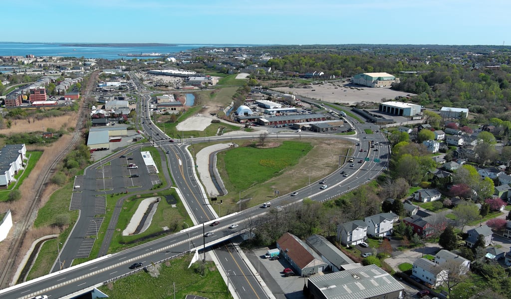 A bridge onramp leading to the Pell Bridge over water. 