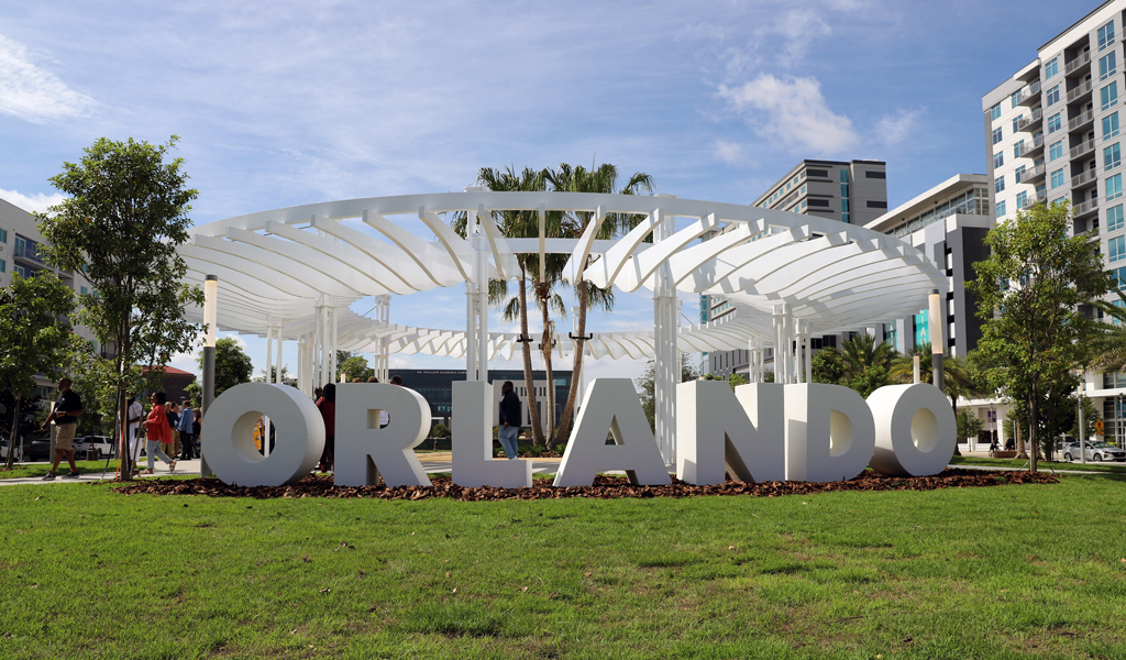 A white sculpture in a park that spells out the word Orlando.