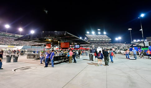 Fans walk, mingle, and play games in the Fan Zone at the Richmond International Raceway.