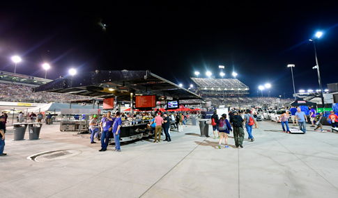 Fans walk, mingle, and play games in the Fan Zone at the Richmond International Raceway.